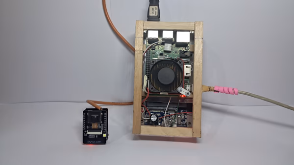 Physical Raspberry Pi 3B+ & ESP32-CAM hardware setup in custom wooden enclosure